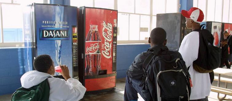 Students buy drinks from vending machines.