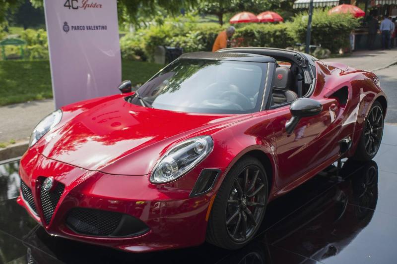A red Alfa Romeo 4C is parked.