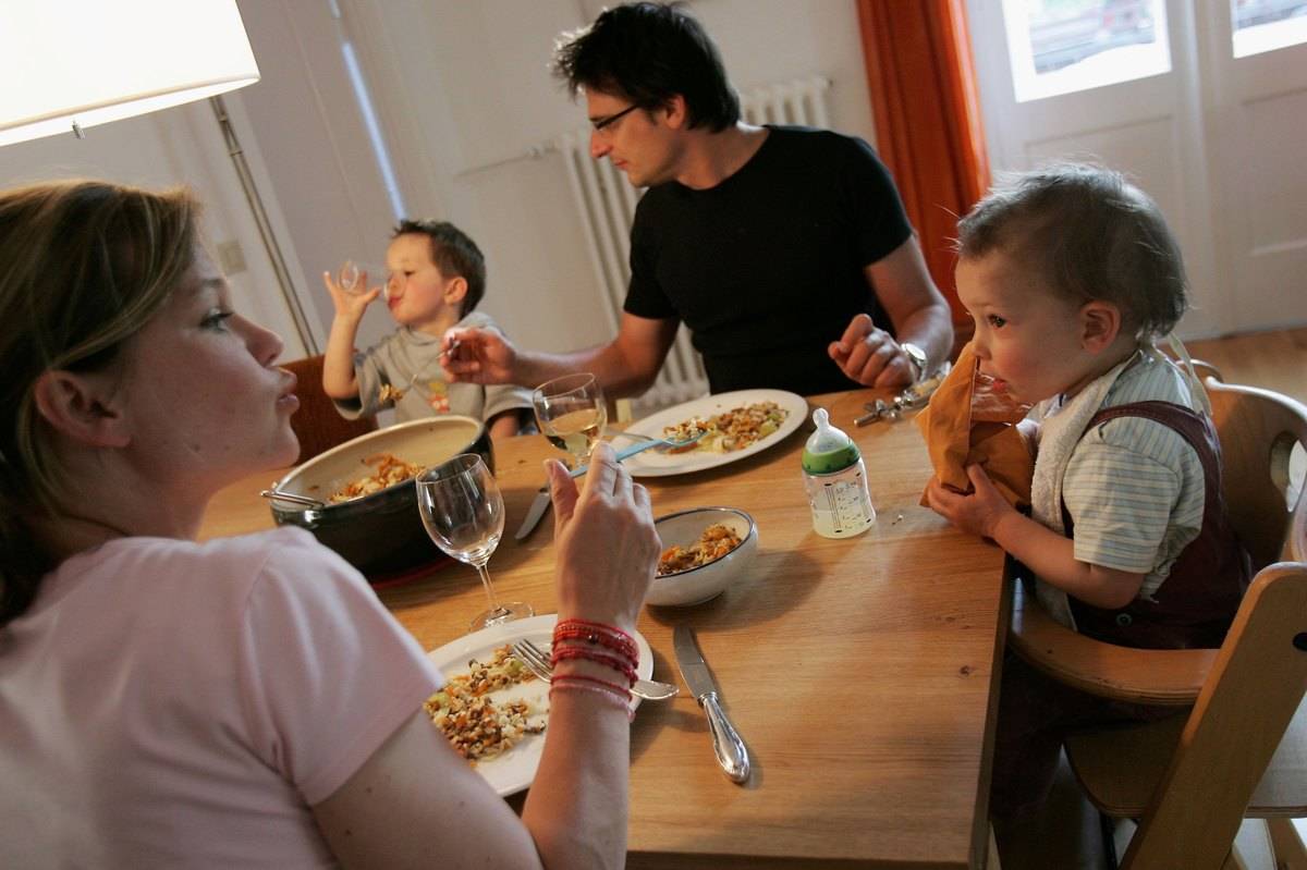 A family eats dinner together.