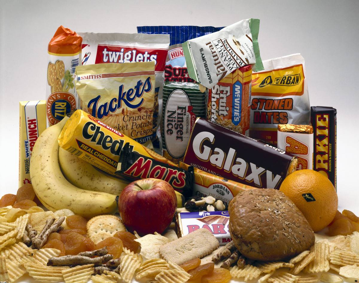 Fruit and cracker snacks are in a pile.