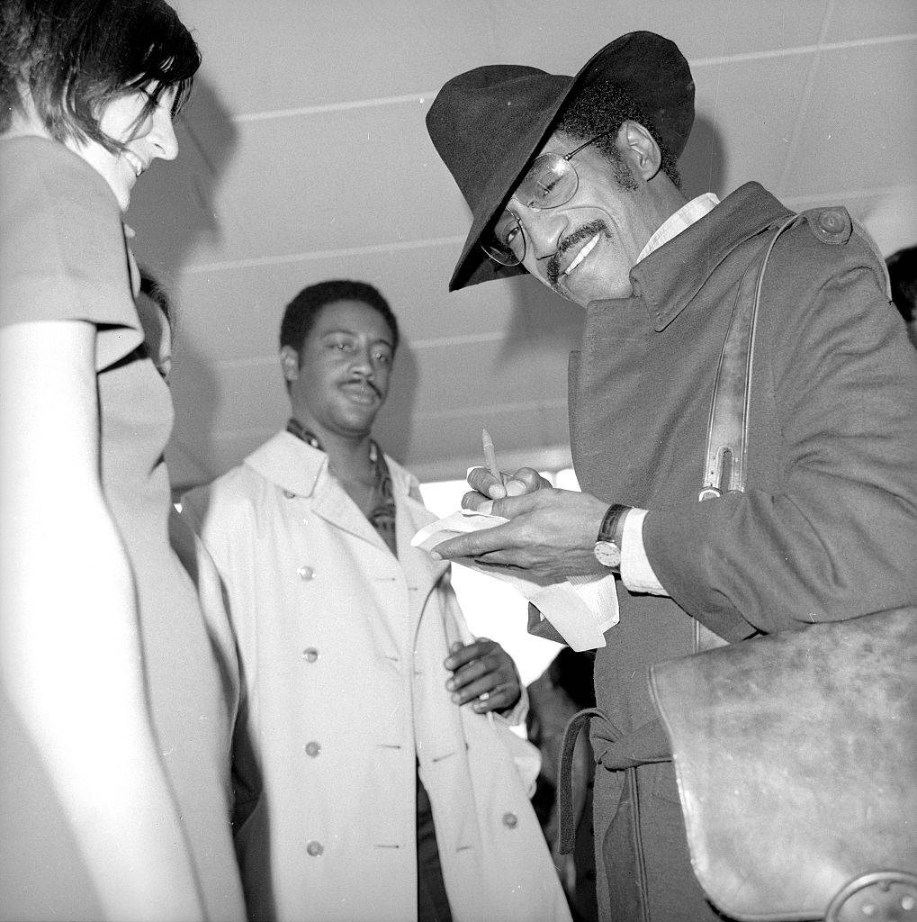 Sammy Davis Jnr signing autographs at Heathrow