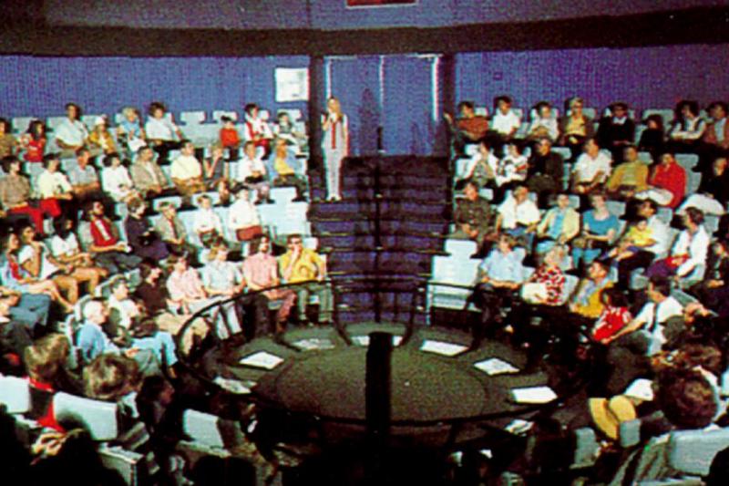 flight to the moon people sitting in a round theater on flight to the moon at disneyland