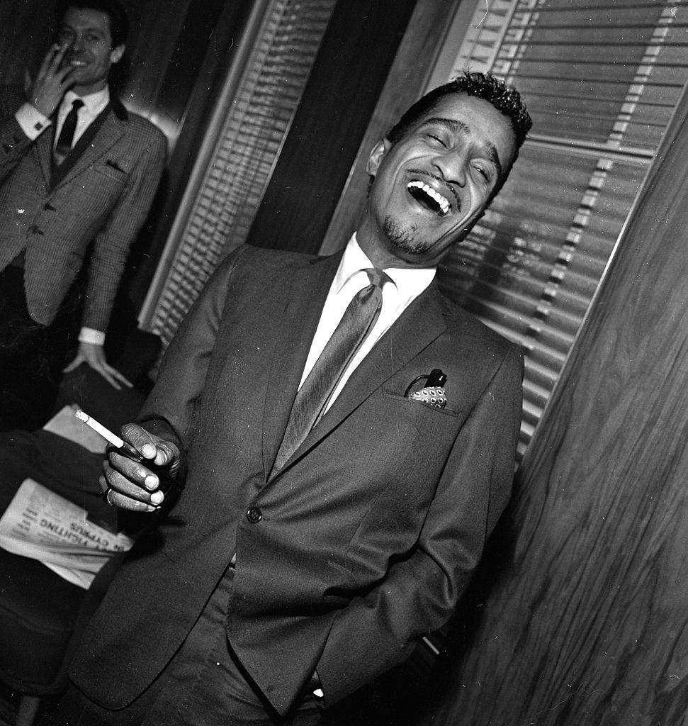Sammy Davis Jnr at a press reception in Soho cinema showing slips of his new film Robin and his hood men. 