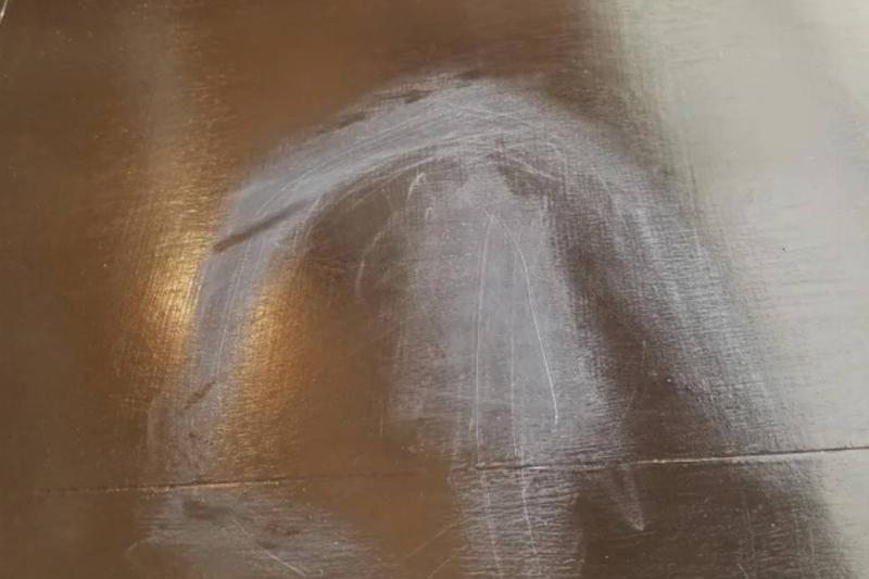 sandpaper scratching on top of wood table