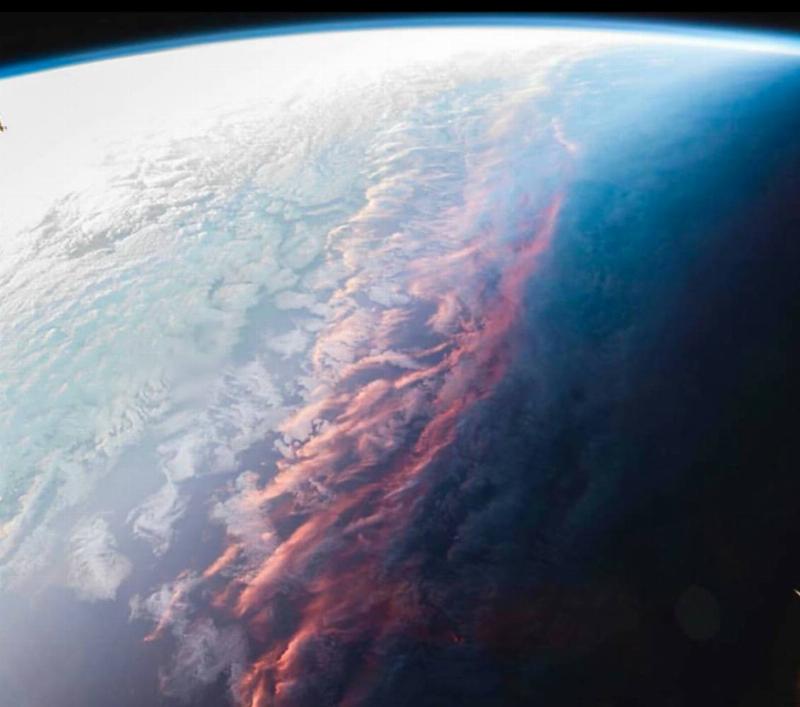 red tinge shown across line separating light from dark on earth's surface