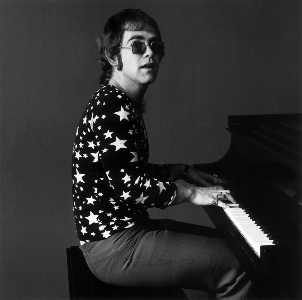 Elton John playing the piano  