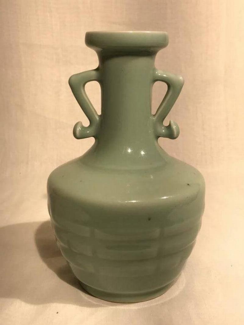 vase with handles that look like arms akimbo