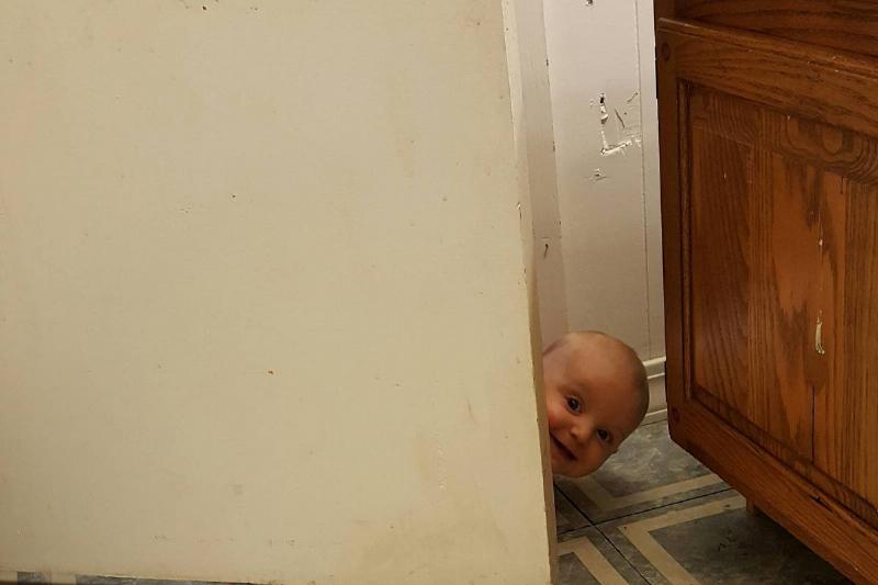 baby peeking through the door
