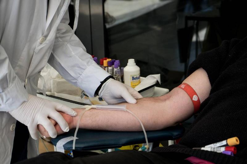 A doctor tests a donor's blood.