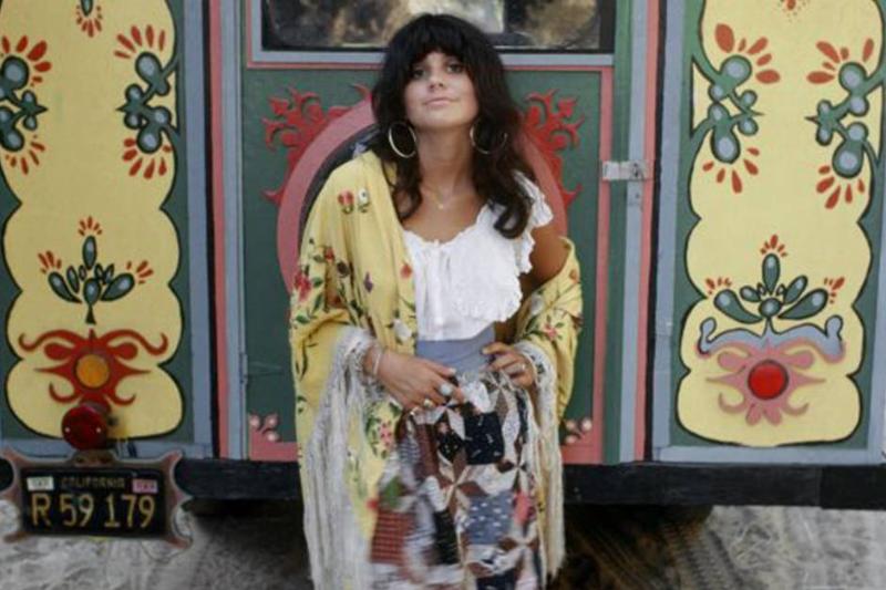 Linda Ronstadt standing near a colorful bus