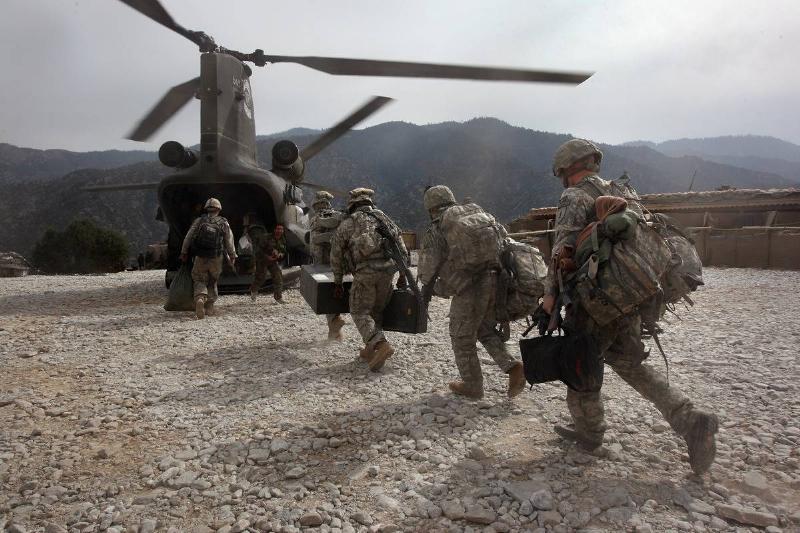 U.S. soldiers board an Army Chinook transport helicopter