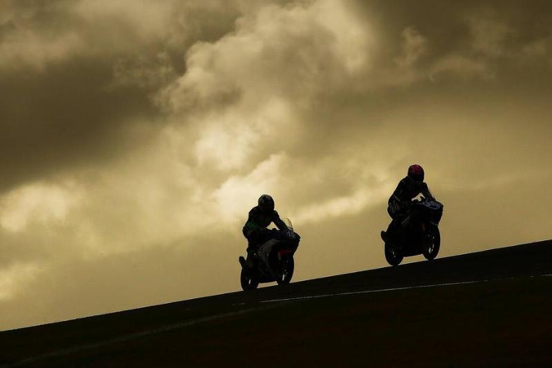 australia motocycles-923972388 Motorcycle rides drive up a cliff in Australia.