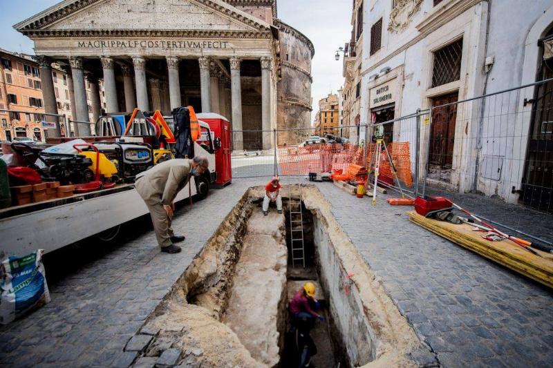 Man looking into sinkhole 
