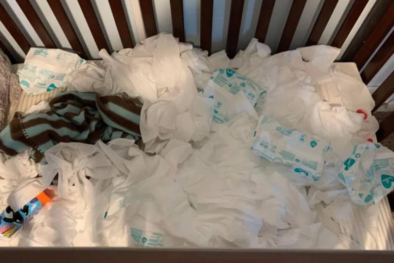 hundreds of baby wipes strewn across crib