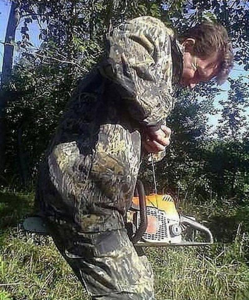 bad move person in camo with chainsaw between legs