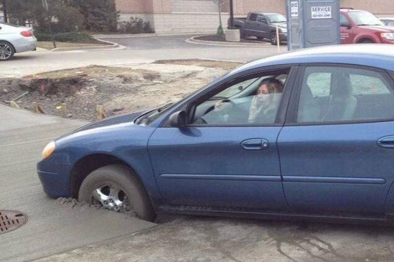 driving in wet cement car with front wheels caught in wet concrete