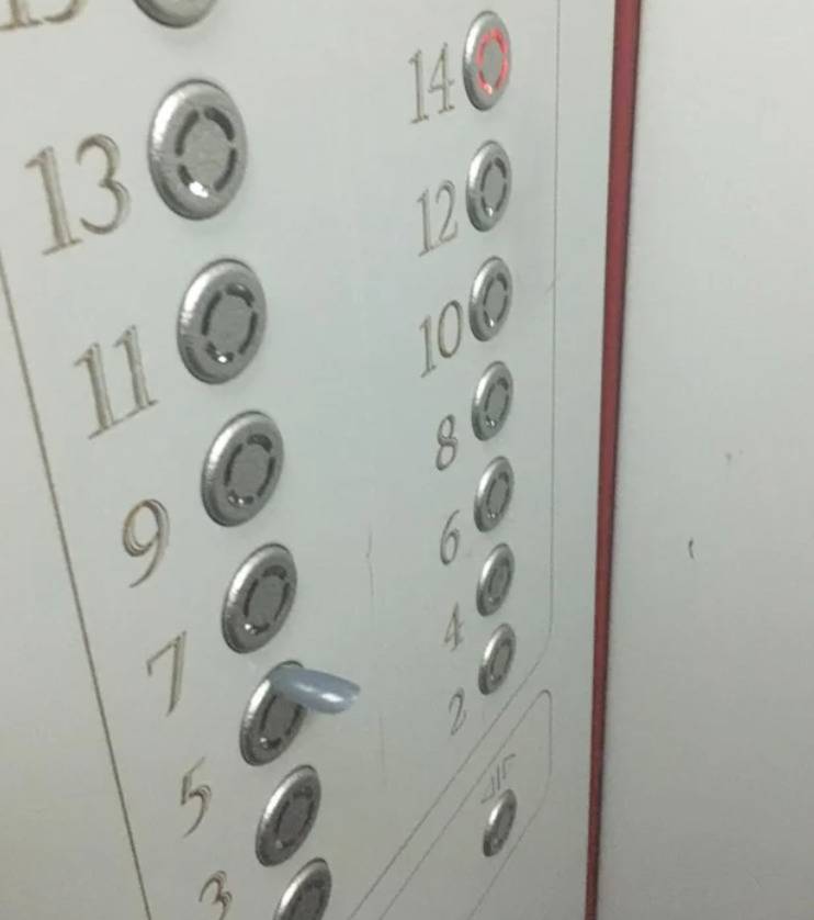 fake fingernail stuck in elevator button