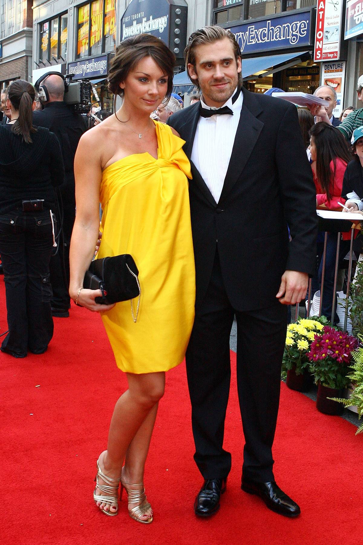 Henrik and Emma pose on a red carpet.