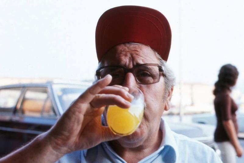 orange juice-1224461488 A man drinks a glass of orange juice.