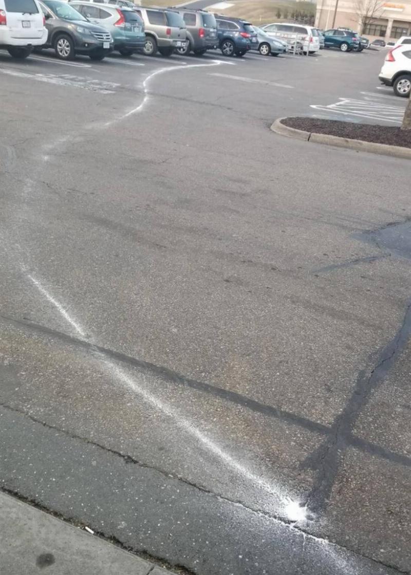 squiggly white line on parking lot ground