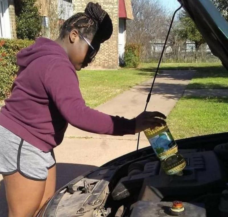 canola oil woman putting canola oil into her car
