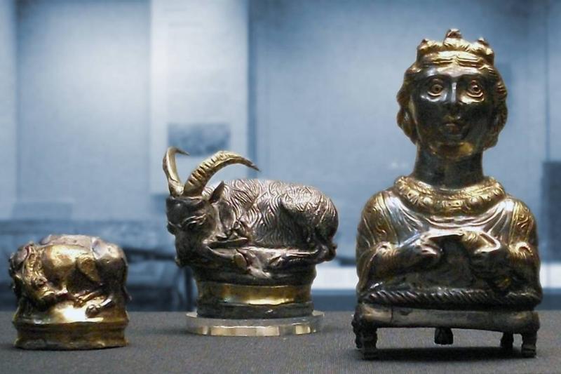 Three miniature sculptures from the Hoxne Hoard are displayed.