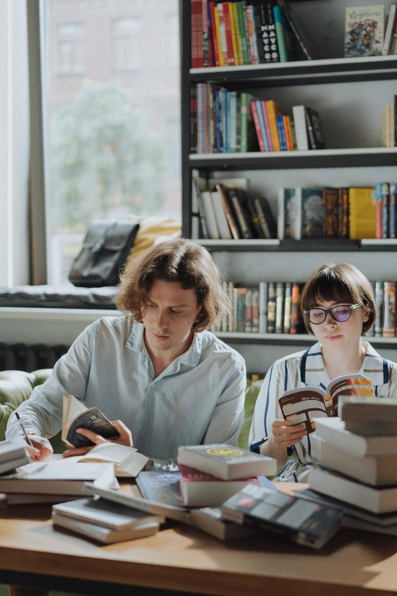 couple sitting in a book store reading together 