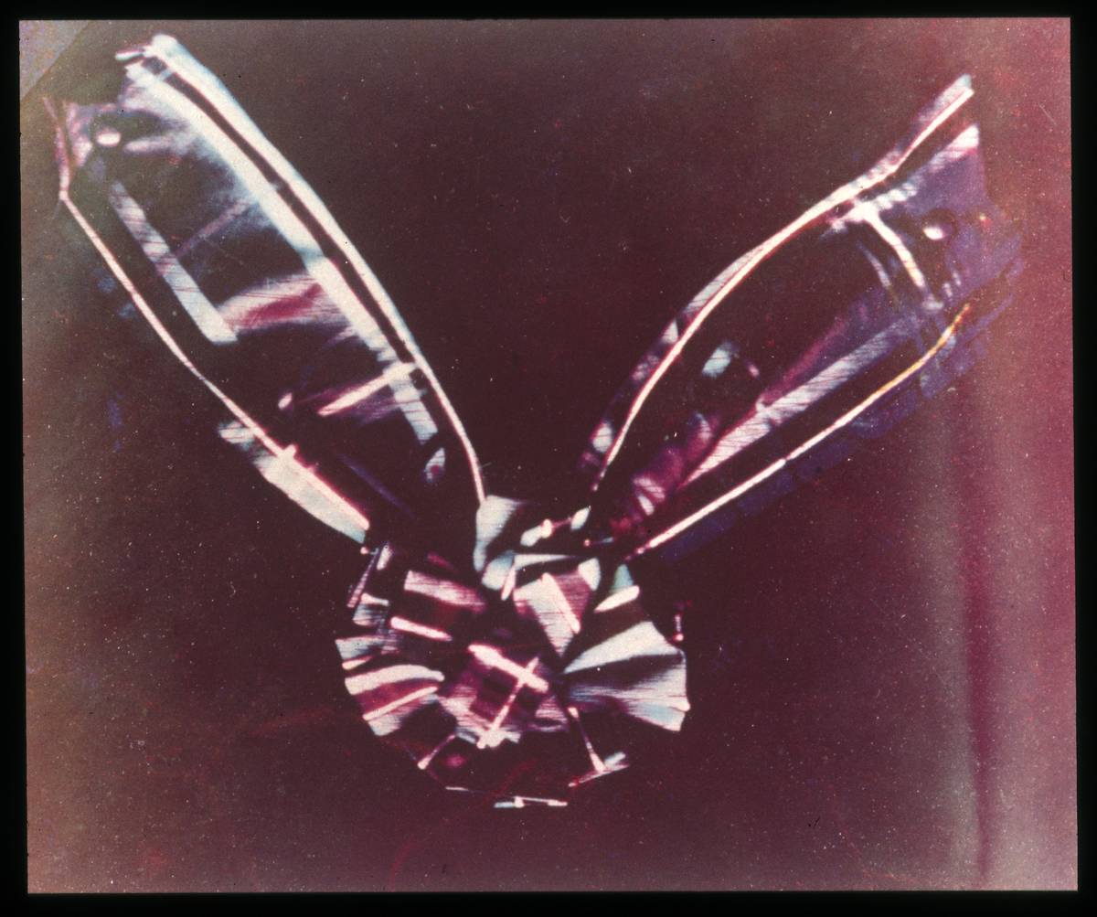 The first color photo depicts a multi-colored ribbon tied in a knot.