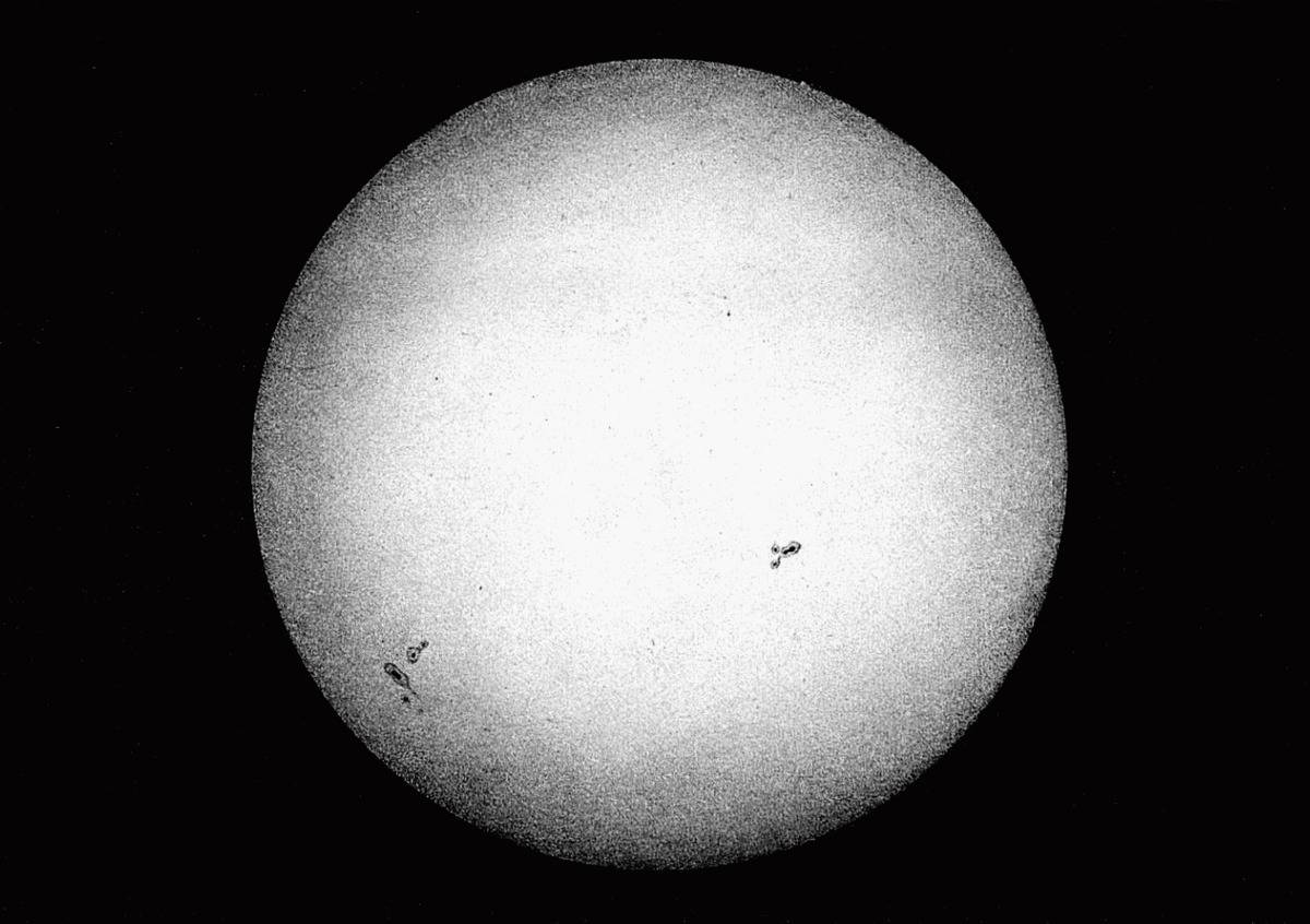 The first picture of the sun shows a black-and-white orb with sun spots.