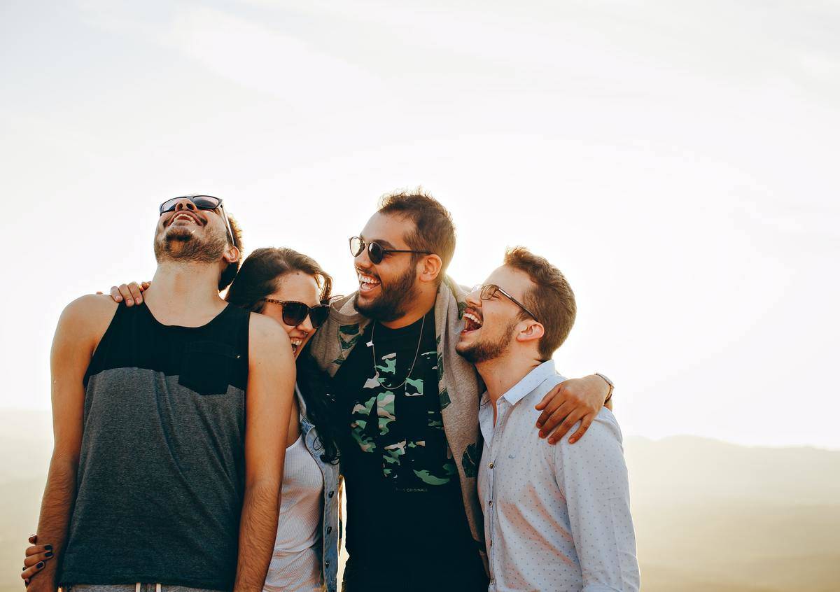four friends laughing together 