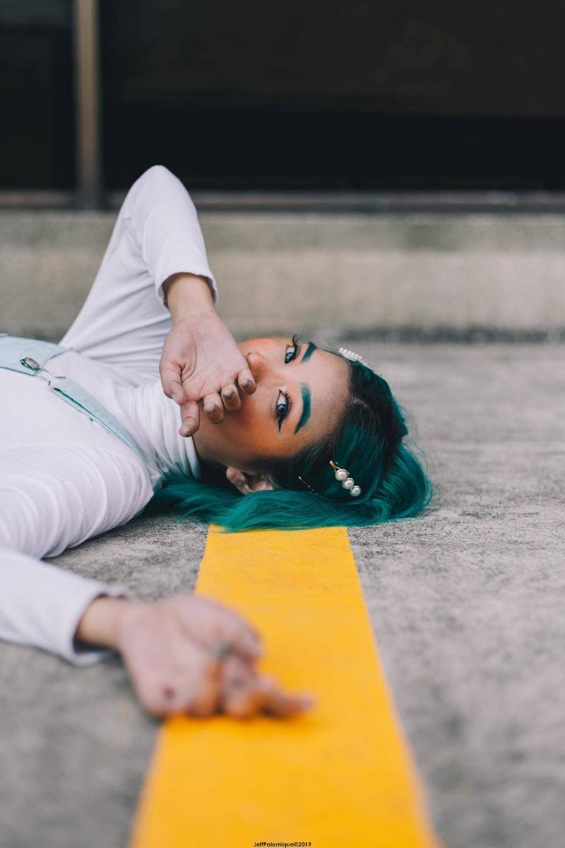 a woman lying down on the road 