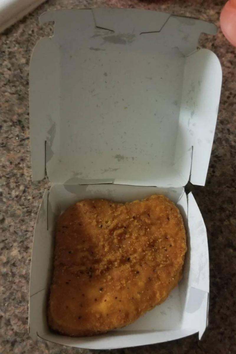 nugget box with a singular large piece of breaded chicken