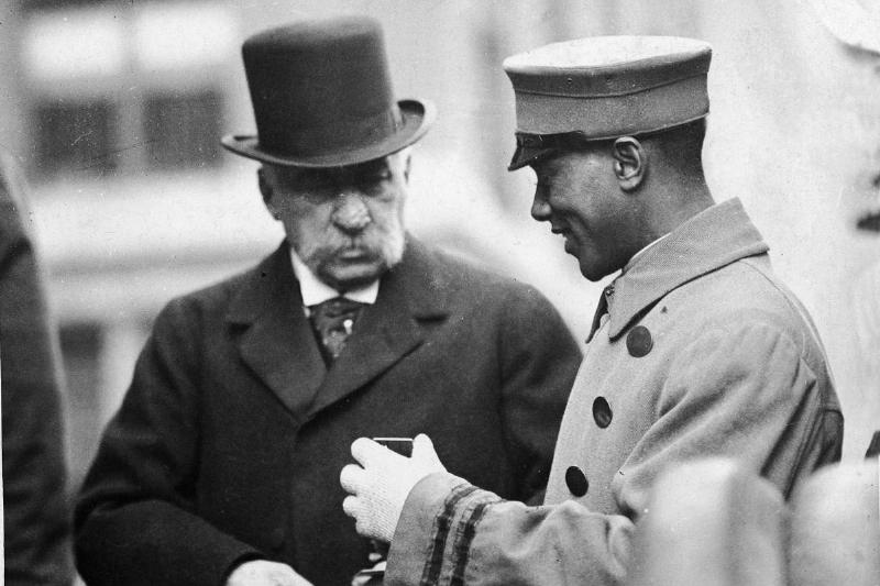 A bellboy speaks with JP Morgan in the early 1900s.