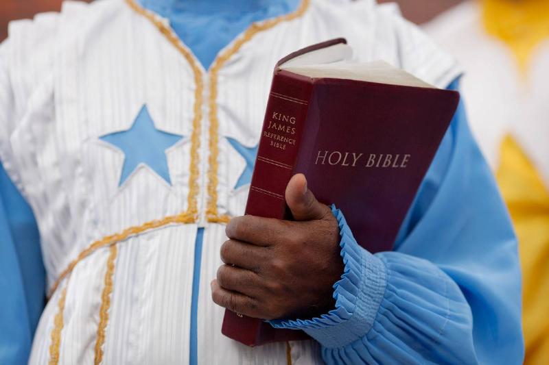 A church member carries a copy of the King James Bible.