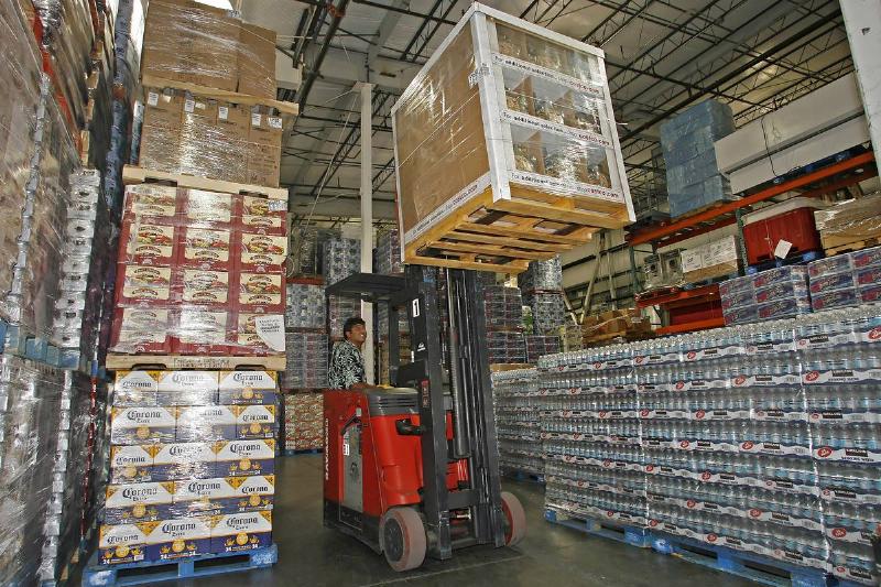 Employee Tony Gallegos uses a forklift to move a pallet of h
