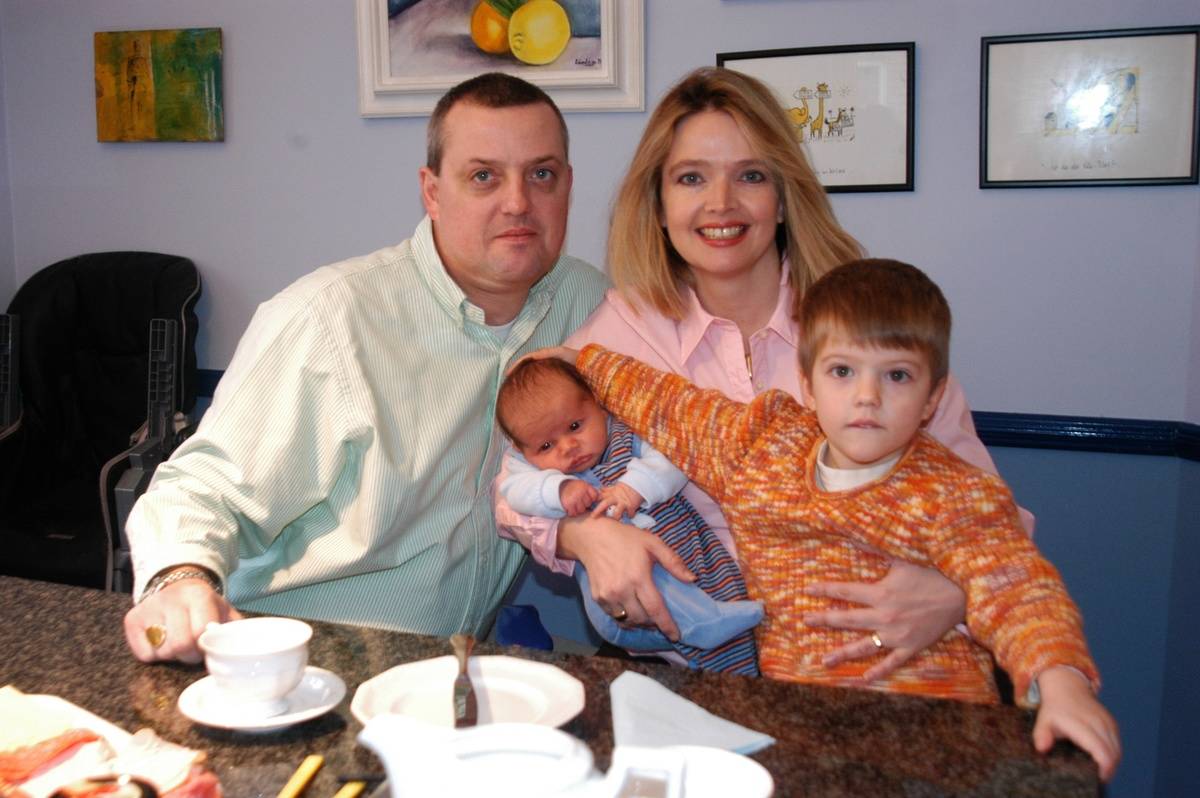 mother, father, and two sons eating breakfast