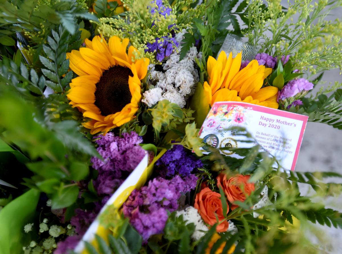 LAPD officers deliver flowers to deserving mothers.