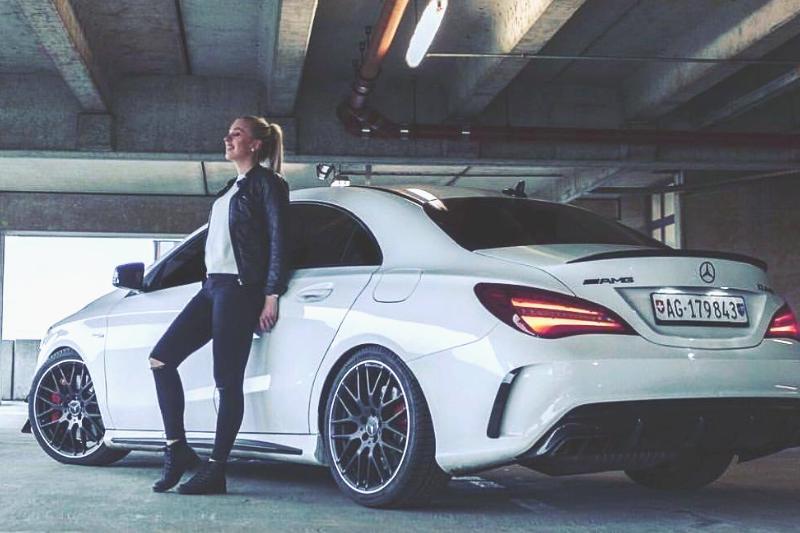 woman standing next to Mercedes-Benz CLA 45 AMG The stunning Mercedes-Benz CLA 45 AMG