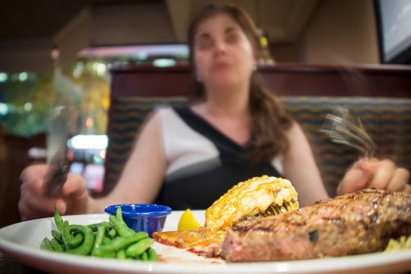 Closeup of a steak and lobster dish on a white plate in... Closeup of a steak and lobster dish on a white plate in...