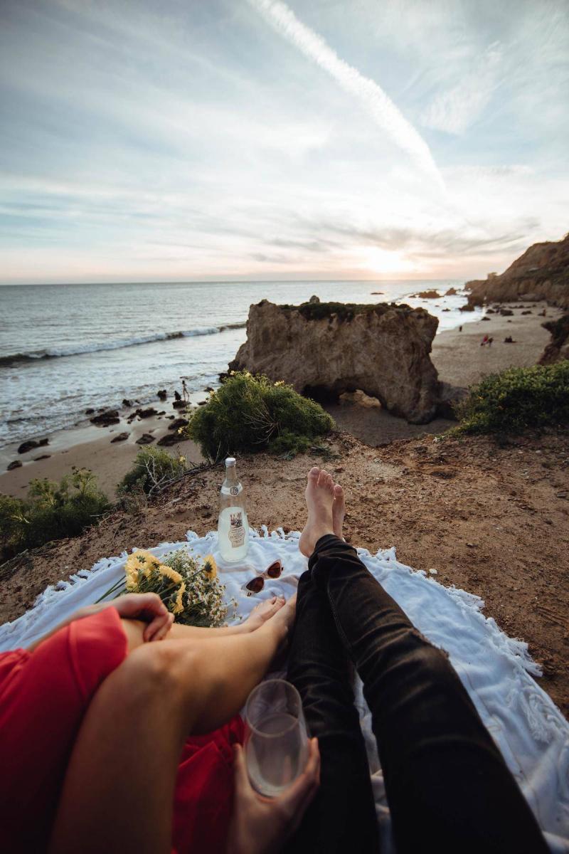 Couple's legs at beach on date