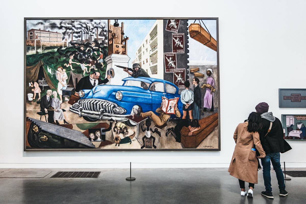 Couple stares at art on museum wall