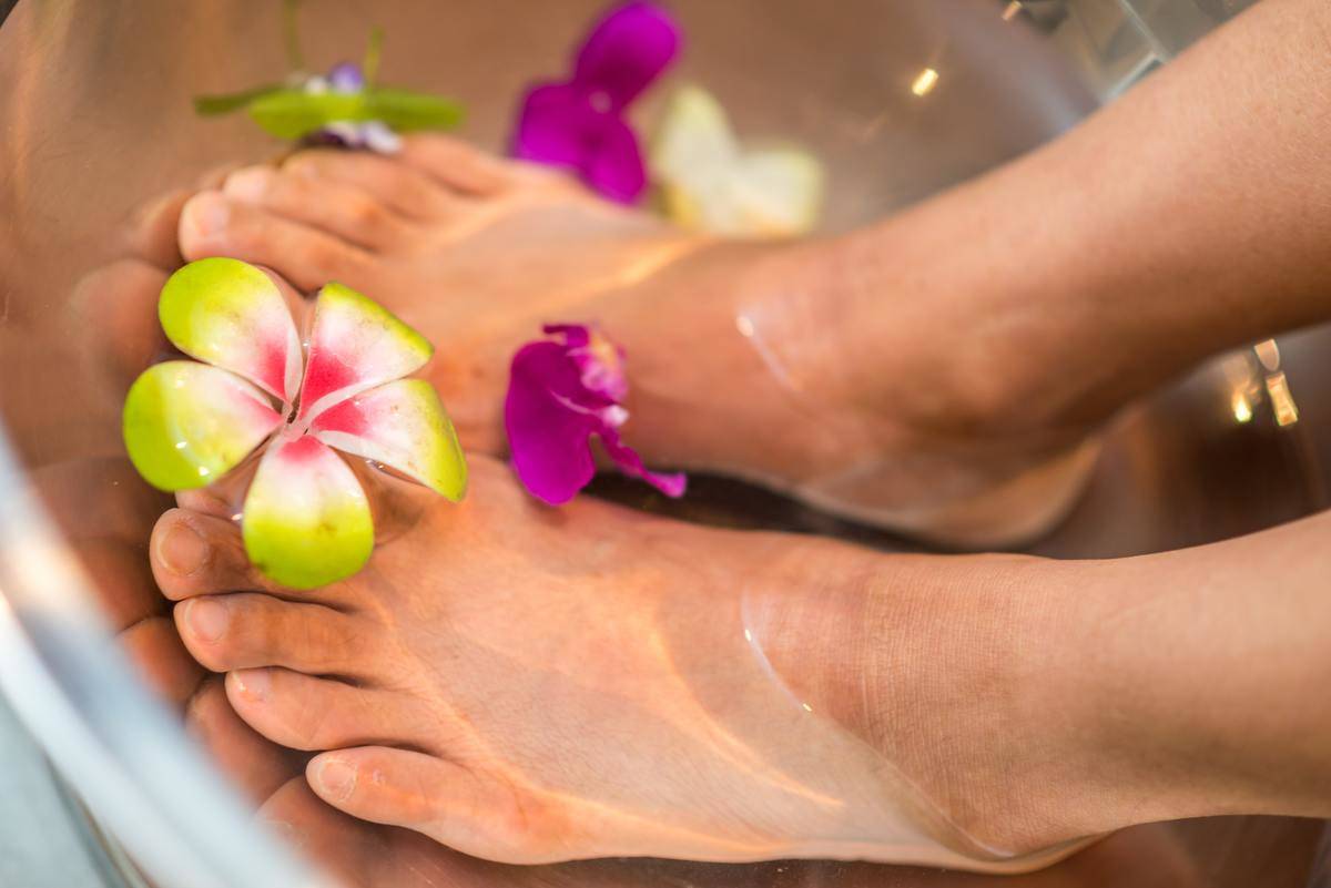 Foot bath with flower between toes