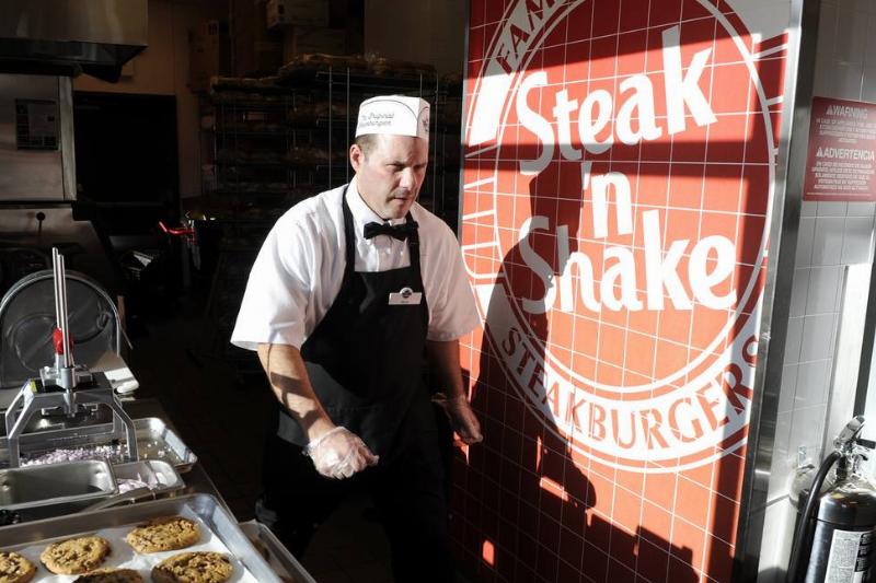 Steak'n Shake employee, Steve Jones, walks to his next task in the kitchen before the grand opening of the Steak'n Shake in Centennial Thursday morning. Andy Cross, The Denver Post Steak'n Shake employee, Steve Jones, walks to his next task in the kitchen before the grand opening of the Steak'n Shake in Centennial Thursday morning. Andy Cross, The Denver Post