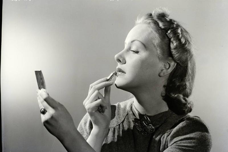 Woman Applying Lipstick