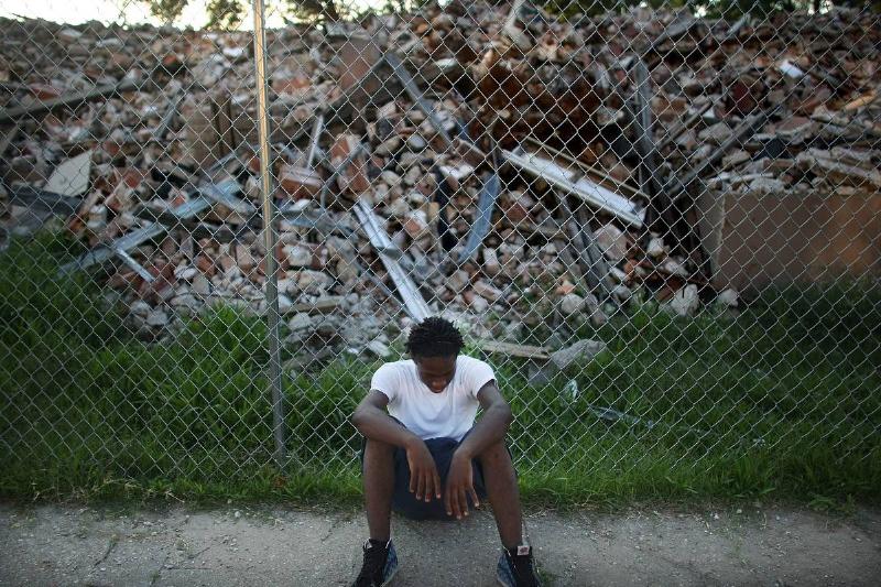 New Orleans A man sits in front of a demolished building in New Orleans.