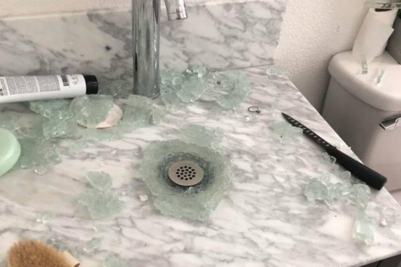 glass bathroom sink shattered in fragments