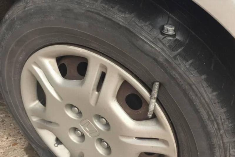 metal spike punctured hole through tire