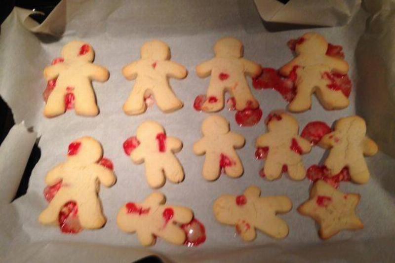cookies shaped like people with melted candy canes on them