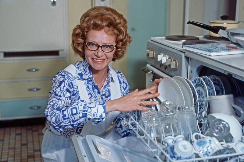 A woman stocks her dishwasher in 1969.