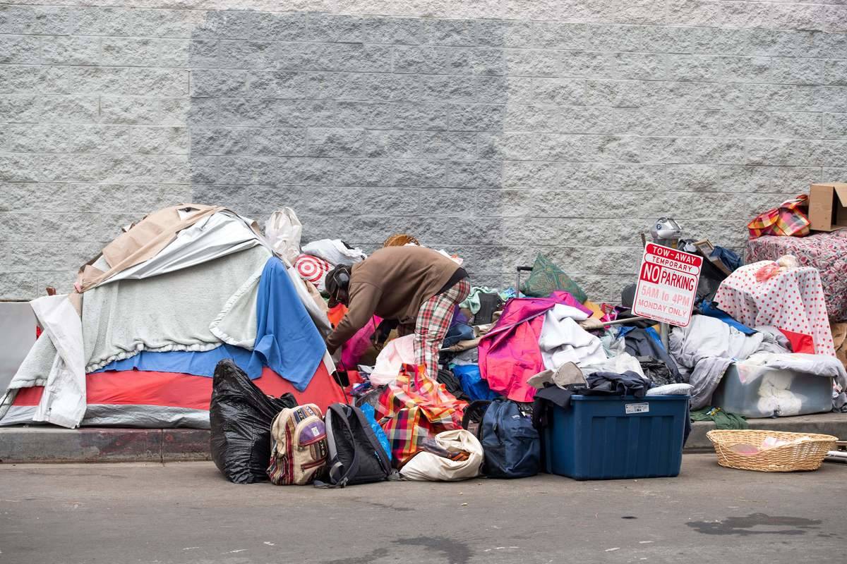 encampment Activists help to clean the streets of a homeless area.